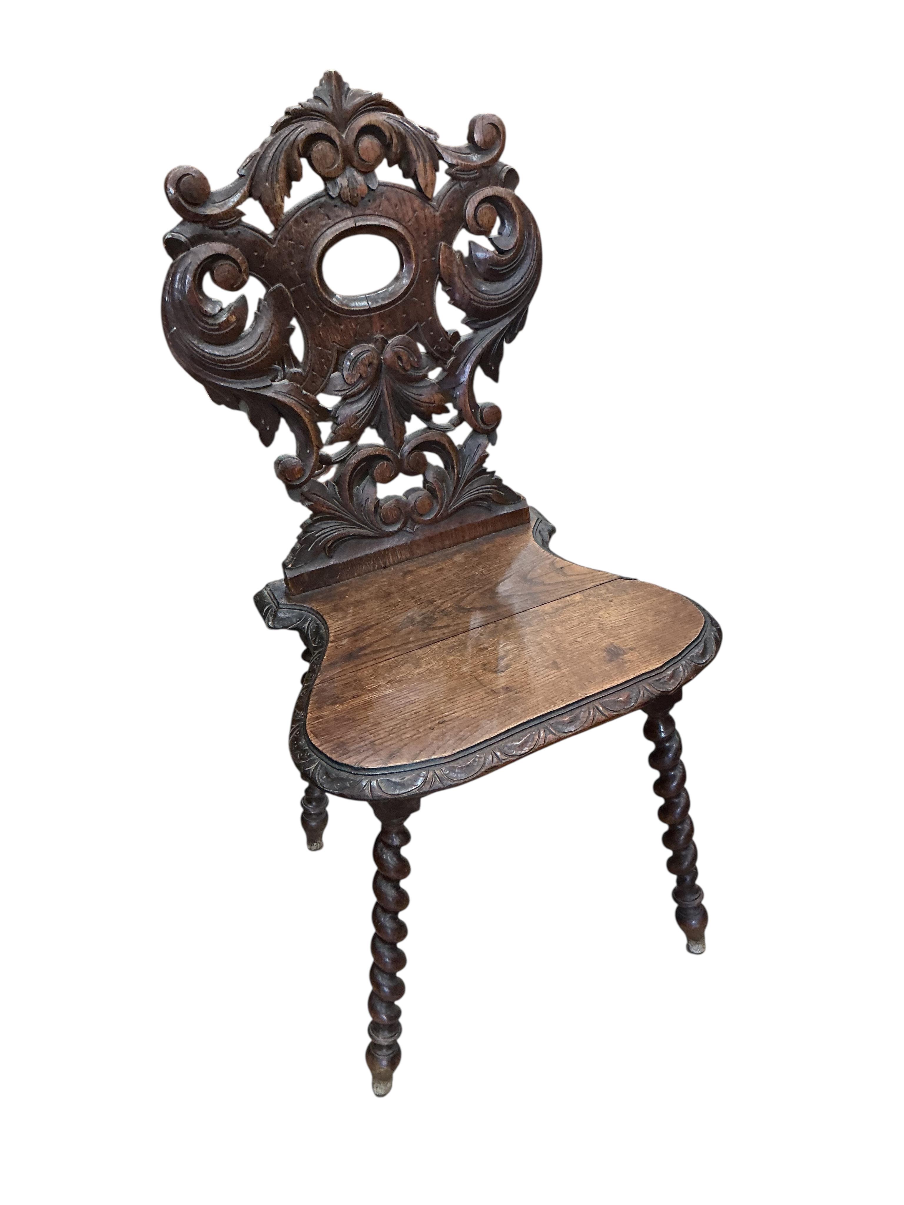 A pair of 19th century carved oak hall chairs, width 45cm, depth 34cm, height 94cm